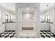 Luxurious bathroom featuring a large marble shower, double sinks, and black and white flooring at 2890 Howell Mill Rd, Atlanta, GA 30327