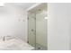 Glass-enclosed shower with white tile and pebble floor in a modern bathroom at 2890 Howell Mill Rd, Atlanta, GA 30327