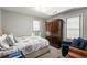 Neutral bedroom with armoire, natural light, and a cozy chair at 2890 Howell Mill Rd, Atlanta, GA 30327