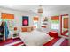 Eclectic bedroom with colorful decor, unique artwork, and bright patterned flooring at 2890 Howell Mill Rd, Atlanta, GA 30327