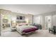 Bright bedroom with a large bed, bench, and an adjoining sitting room at 2890 Howell Mill Rd, Atlanta, GA 30327