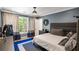 Bedroom featuring blue accent wall, large window and carpeted floor at 2890 Howell Mill Rd, Atlanta, GA 30327