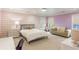 Bedroom with lilac walls, a gray couch, a large window and a white carpet at 2890 Howell Mill Rd, Atlanta, GA 30327