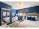 Stylish bedroom with blue walls, plush carpet, and decorative mirror at 2890 Howell Mill Rd, Atlanta, GA 30327