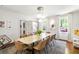 Chic dining room with a marble tabletop, tan upholstered chairs, and view to the backyard at 2890 Howell Mill Rd, Atlanta, GA 30327