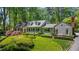 Beautiful home with well-manicured landscaping, dormer windows, and a brick chimney at 2890 Howell Mill Rd, Atlanta, GA 30327