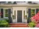 Elegant front entrance with decorative molding, black shutters, and a brick walkway at 2890 Howell Mill Rd, Atlanta, GA 30327