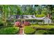 Charming home with a brick walkway, manicured landscaping, and a lush green lawn at 2890 Howell Mill Rd, Atlanta, GA 30327