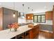 Bright kitchen boasts a spacious island with barstool seating, and professional grade appliances at 2890 Howell Mill Rd, Atlanta, GA 30327