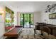 Bright living room with large windows, comfortable seating, and a view of the backyard at 2890 Howell Mill Rd, Atlanta, GA 30327