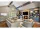 Open living room featuring a stone fireplace, custom built-ins, and hardwood floors at 2890 Howell Mill Rd, Atlanta, GA 30327