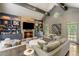 Inviting living room with stone fireplace, custom built-ins, and vaulted ceiling with exposed beams at 2890 Howell Mill Rd, Atlanta, GA 30327