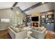 Bright living room with stone fireplace, built-in shelving, large windows, and comfortable seating arrangement at 2890 Howell Mill Rd, Atlanta, GA 30327