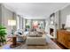 Spacious living room with neutral tones, fireplace, and ample natural light from large windows at 2890 Howell Mill Rd, Atlanta, GA 30327