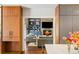 Open living area with a stone fireplace, built in shelving and convenient access to the kitchen at 2890 Howell Mill Rd, Atlanta, GA 30327
