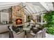 Cozy outdoor fireplace with seating and an outdoor kitchen area at 2890 Howell Mill Rd, Atlanta, GA 30327