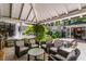 Outdoor living area includes comfortable seating, an outdoor kitchen, and a dining table at 2890 Howell Mill Rd, Atlanta, GA 30327