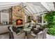 This outdoor living area features a fireplace, kitchen, and comfortable seating at 2890 Howell Mill Rd, Atlanta, GA 30327