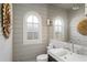 Stylish powder room featuring shiplap walls, arched window, and vessel sink at 2890 Howell Mill Rd, Atlanta, GA 30327