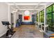 Spacious recreation room with shiplap, a large window, stone floor, and a full service bar at 2890 Howell Mill Rd, Atlanta, GA 30327
