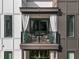 Exterior shot showing a charming balcony, complete with seating and elegant white privacy curtains at 383 Grant Se Cir # 1634, Atlanta, GA 30315