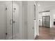 Modern bathroom featuring glass enclosed shower with white subway tiles, leading to kitchen at 383 Grant Se Cir # 1634, Atlanta, GA 30315