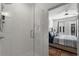 Walk-in shower with glass door and view to main bedroom with plush bedding at 383 Grant Se Cir # 1634, Atlanta, GA 30315