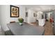 Open-concept living room with modern kitchen island, stainless steel appliances, and dining space at 383 Grant Se Cir # 1634, Atlanta, GA 30315