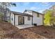 A charming white home boasts a spacious backyard and patio, perfect for outdoor entertaining at 3840 Natalie Way, Ellenwood, GA 30294