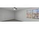 Spacious bedroom with a ceiling fan and natural light from two windows at 3840 Natalie Way, Ellenwood, GA 30294