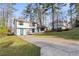 Split level home with ample parking and a lush lawn, nestled among mature trees at 3840 Natalie Way, Ellenwood, GA 30294