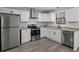 Modern kitchen boasts stainless steel appliances, granite countertops and sleek, white cabinetry at 3840 Natalie Way, Ellenwood, GA 30294
