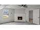 Cozy living room featuring a gray carpet, a fireplace and a view of backyard through the window at 3840 Natalie Way, Ellenwood, GA 30294