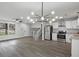 Open concept living and kitchen features sleek flooring, modern lighting, and stainless steel appliances at 3840 Natalie Way, Ellenwood, GA 30294