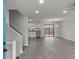 Open concept living space boasts sleek flooring, modern lighting and sliding glass doors to the backyard at 3840 Natalie Way, Ellenwood, GA 30294