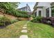 Landscaped backyard with a stone path at 690 Sienna Dr, Cumming, GA 30040