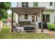 Backyard patio with a pergola, seating, and grill at 690 Sienna Dr, Cumming, GA 30040