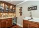 Wet bar includes wine storage, beverage fridge, designer tile backsplash, and white quartz countertop at 690 Sienna Dr, Cumming, GA 30040