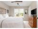 Bedroom featuring neutral carpet, a window with a view, and a wood dresser at 690 Sienna Dr, Cumming, GA 30040