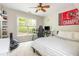 Bright bedroom featuring neutral walls, plush carpet, natural light, and a gaming area at 690 Sienna Dr, Cumming, GA 30040