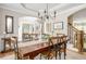 Formal dining room with hardwood floors, archway, and open access to other living spaces at 690 Sienna Dr, Cumming, GA 30040
