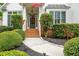 Inviting front entrance with brick steps, manicured bushes, and walkway at 690 Sienna Dr, Cumming, GA 30040