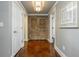 Hallway features stylish flooring, neutral walls, doors to additional rooms, and an accent wall hanging at 690 Sienna Dr, Cumming, GA 30040