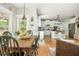 Open-concept kitchen with white cabinets, hardwood floors, and stainless steel appliances at 690 Sienna Dr, Cumming, GA 30040