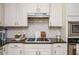 Elegant kitchen with gas stove, stainless steel appliances, and white subway tile backsplash at 690 Sienna Dr, Cumming, GA 30040