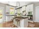 Stylish kitchen island with seating, granite countertops, and stainless steel appliances at 690 Sienna Dr, Cumming, GA 30040