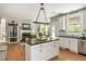 Open concept kitchen with island, stainless steel appliances, and hardwood floors at 690 Sienna Dr, Cumming, GA 30040