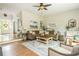 Open-concept living area featuring hardwood floors, comfortable seating, and abundant natural light at 690 Sienna Dr, Cumming, GA 30040