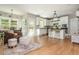 Stylish interior seamlessly combines kitchen and living, with white cabinetry and wooden floors at 690 Sienna Dr, Cumming, GA 30040
