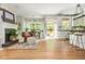 Open-concept living space with dining area, modern kitchen, and outdoor access at 690 Sienna Dr, Cumming, GA 30040